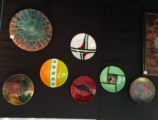 several plates are on display in a room