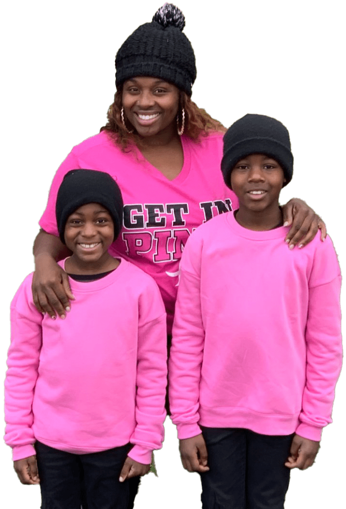a woman and two children wearing pink shirts