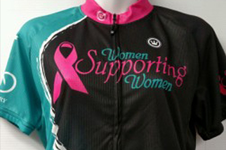 a women's cycling jersey with pink ribbon on it