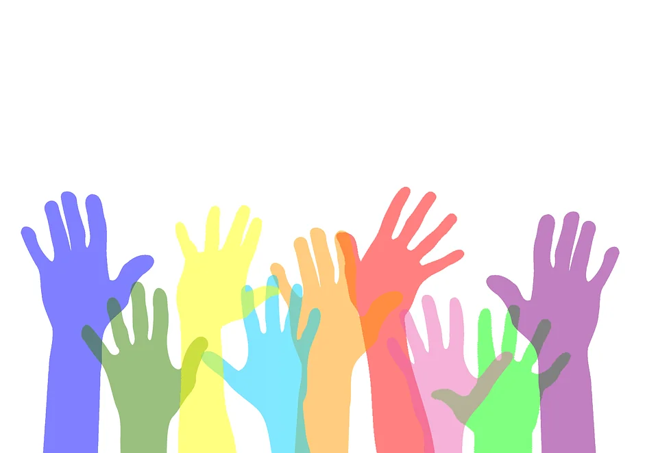 Colorful hands raised